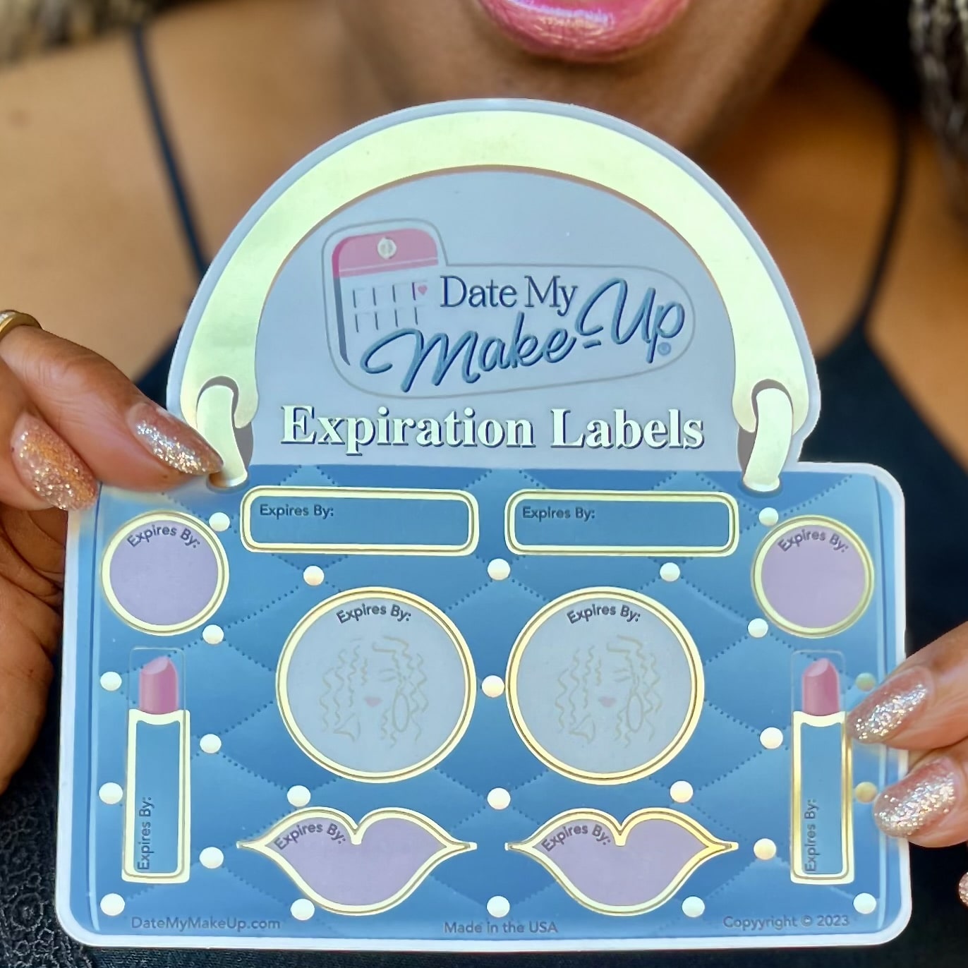 Get organized with ten gold-bordered vinyl labels for make-up expo in blue quilted purse with gold handle.